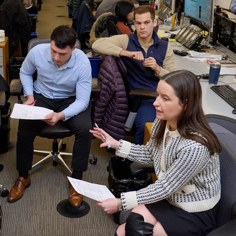 A diverse group of professionals working and collaborating in a modern space